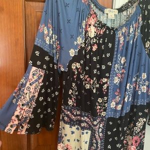 Gently worn flowered blouse with flared sleeves